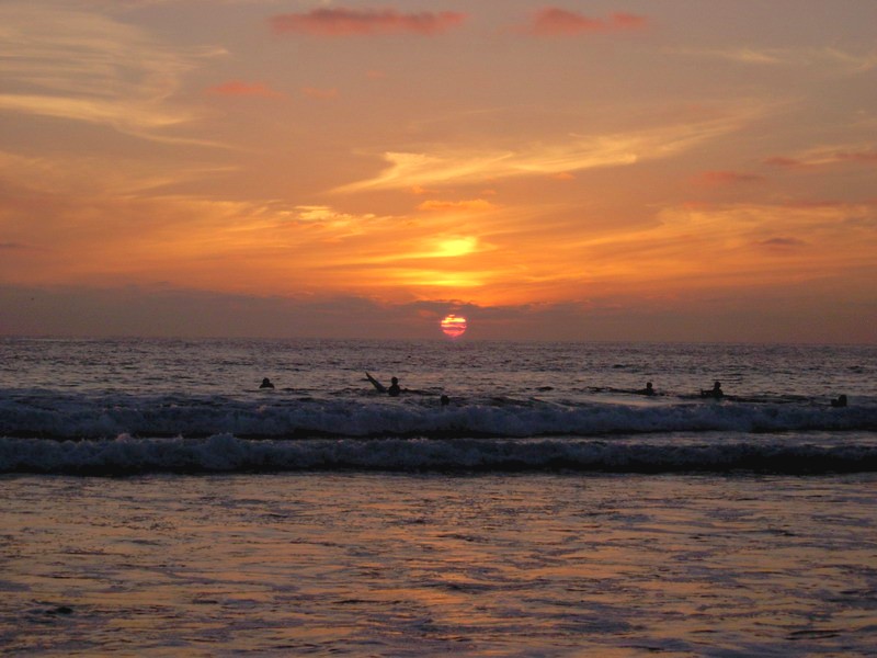 Surfers at sunset in Pacific Beach, San Diego